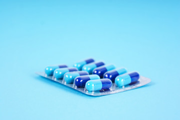 Medical tablets isolated on blue background
