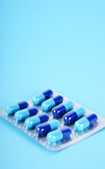 Medical tablets isolated on blue background