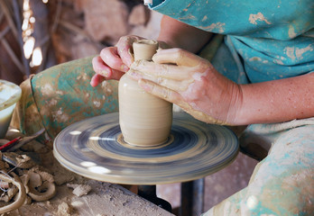 close up of the hands of a potter