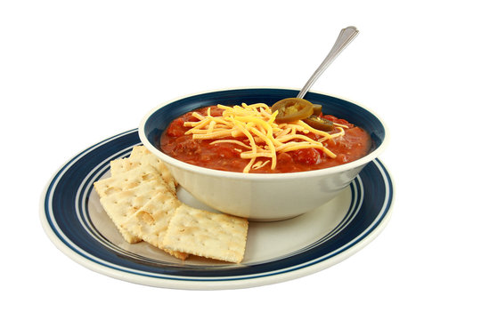 Bowl Of Spicy Red Chili With Cheese And Crackers