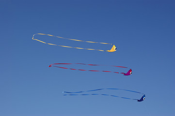 Fish-shaped kites against blue sky