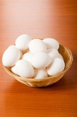 Many white eggs on the wooden table