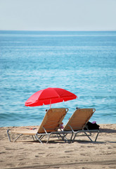 chaise lounge and umbrella on a beach of mediterranean sea in ba