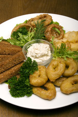 Appetizer made of fried onion, potato and bread