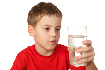 little boy in red sports shirt with water glass in hand