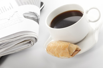 Cup of fragrant coffee on a morning paper business news