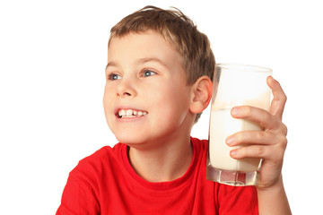 little boy in sports shirt laughs and holds container of milk