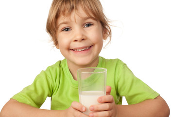 small girl in green blouse drinks the tasty fresh milk