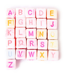 English alphabet on white colored cubes which are set in square