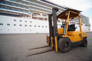 excavator in Qaboos port.  cruise ship in out of focus.