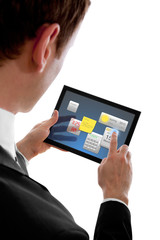 businessman holding a touchpad pc using little widget programms