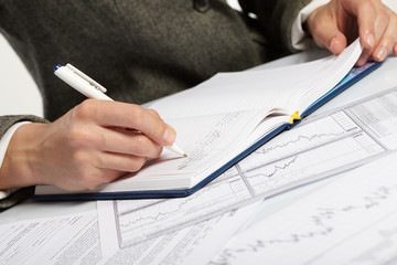 woman’s hand holding a pen