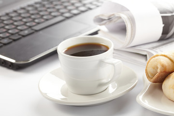 Cup of fragrant coffee on a morning paper business news