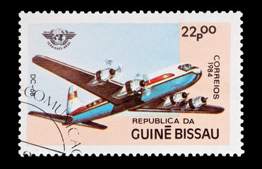 mail stamp from Guinea Bissau featuring a DC-6 aircraft