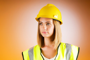 Young girl with hard hat against background