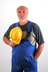 Senior plumber with protective helmet