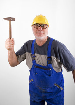 Senior plumber with hammer
