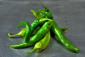 Green chilis on brushed stainless steel tray