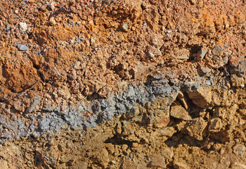 Natural background of mixed colored layers of soil