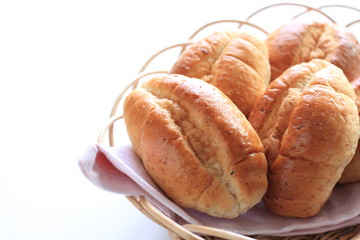 WheatBread roll in basket on white background with copy space