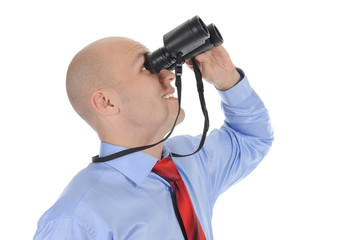 Businessman looking through binoculars