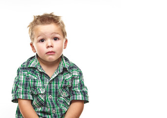 Adorable little boy looking sad.