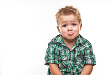 Adorable little boy looking sad.