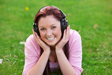 Young woman listening music through headset