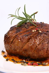 Roast pork decorated with rosemary and some colorful peppercorns