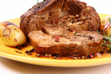 Roast pork with rosemary, onions and colorful peppercorns