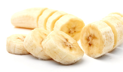 Freshly sliced bananas on a white background.
