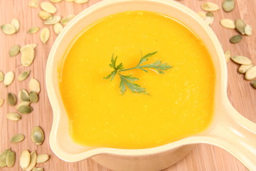 Pumpkin soup decorated with parsley and some pumpkin seeds