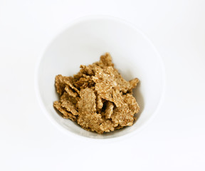 cornflakes in a bowl on white background