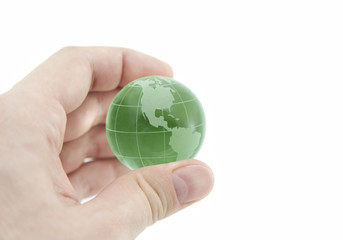 Green crystal globe in hand with clipping path