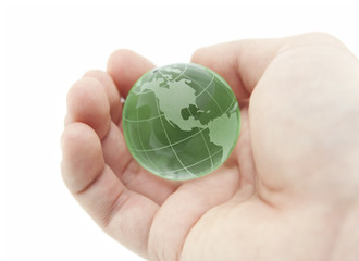 Green crystal globe in hand with clipping path