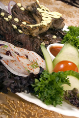 Naklejka na ściany i meble Fried ribs served with vegetables and sauce