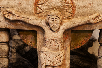 carved old statue from limestone of Jesus Christ crucifixion