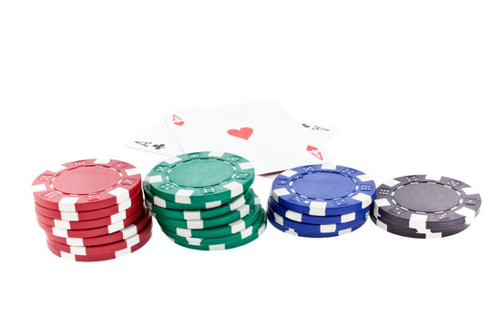 color poker chip stacks and two ace cards