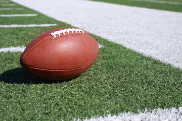 Football on the sideline of field