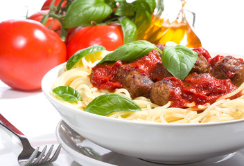 pasta with meatballs and basil with tomato sauce.