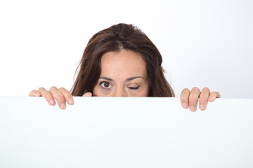 Fototapeta premium Woman showing white board on white background