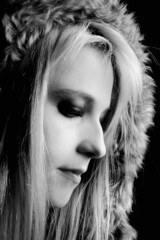 Young elegant girl with fur coat. Studio portrait