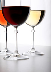 Closeup of glasses full of wine on grey background
