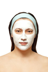 portrait of a young woman with beauty mask on her face isolated