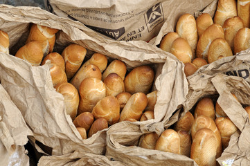 French bread baguettes in brown paper bakers bags