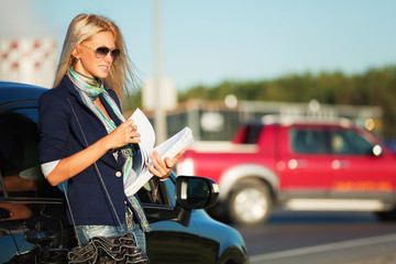 Young businesswoman with financial reports.