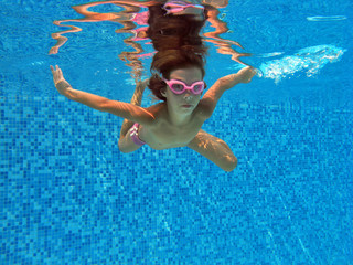 Beautiful underwater girl in swimming pool