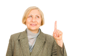senior woman pointing upwards isolated on white