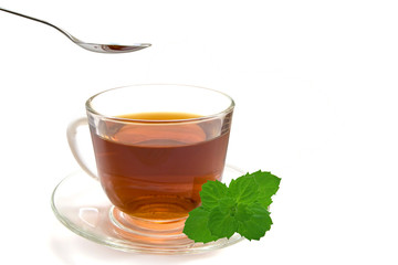 Cup of tea and a spoon isolated on  white