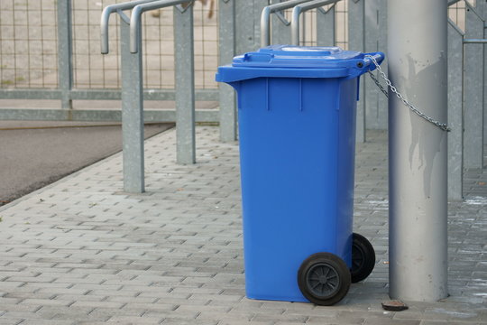 blue plastic garbage bin